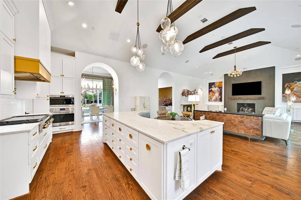 Beautifully updated kitchen with new cabinets, hardware, countertops, banquette breakfast area, hidden coffee bar, Wolfe Appliances, two dishwashers, updated sink and insta-hot faucet.