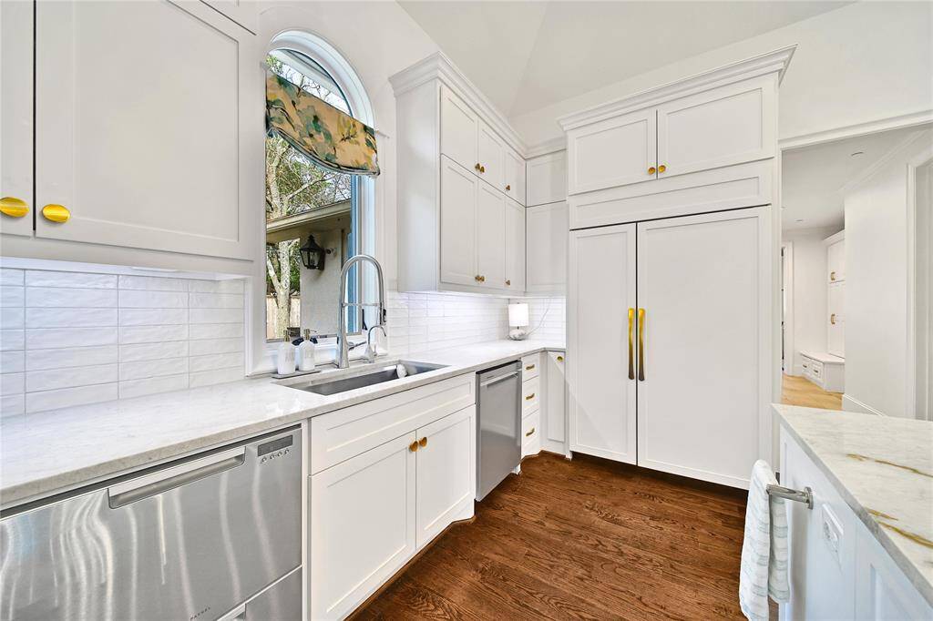 Beautifully updated kitchen with new cabinets, hardware, countertops, banquette breakfast area, hidden coffee bar, Wolfe Appliances, two dishwashers, updated sink and insta-hot faucet.