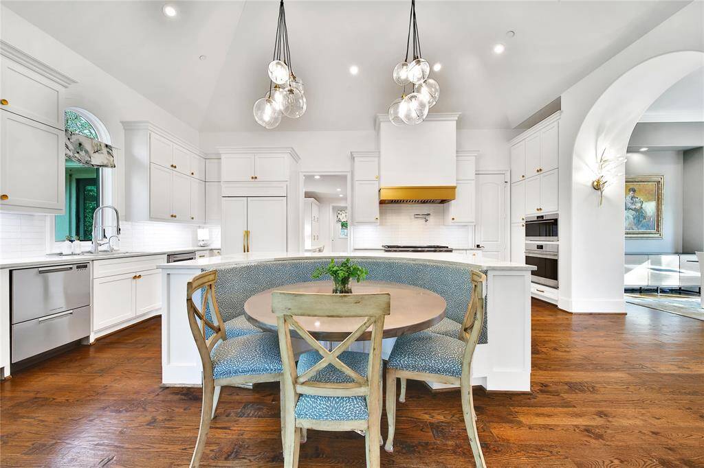 Beautifully updated kitchen with new cabinets, hardware, countertops, banquette breakfast area, hidden coffee bar, Wolfe Appliances, two dishwashers, updated sink and insta-hot faucet.