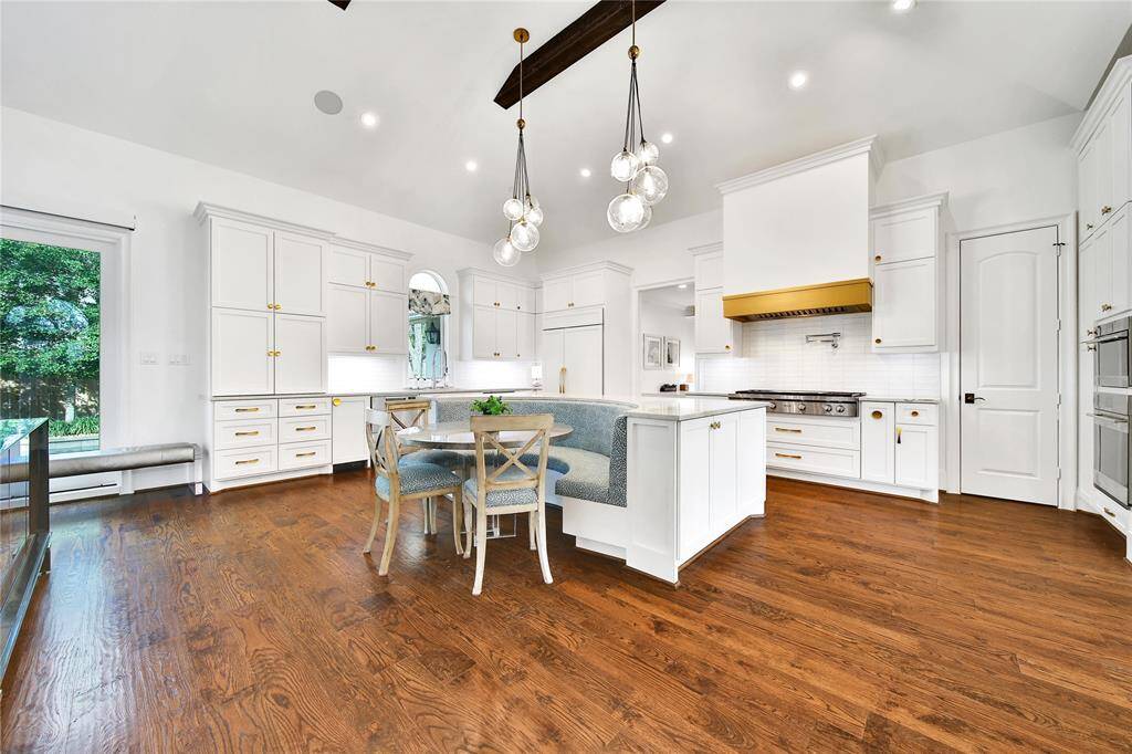 Beautifully updated kitchen with new cabinets, hardware, countertops, banquette breakfast area, hidden coffee bar, Wolfe Appliances, two dishwashers, updated sink and insta-hot faucet.