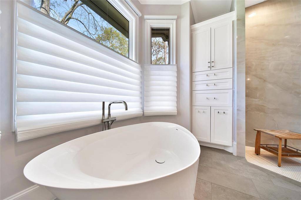 Primary bathroom features spacious shower and soaking tub.
