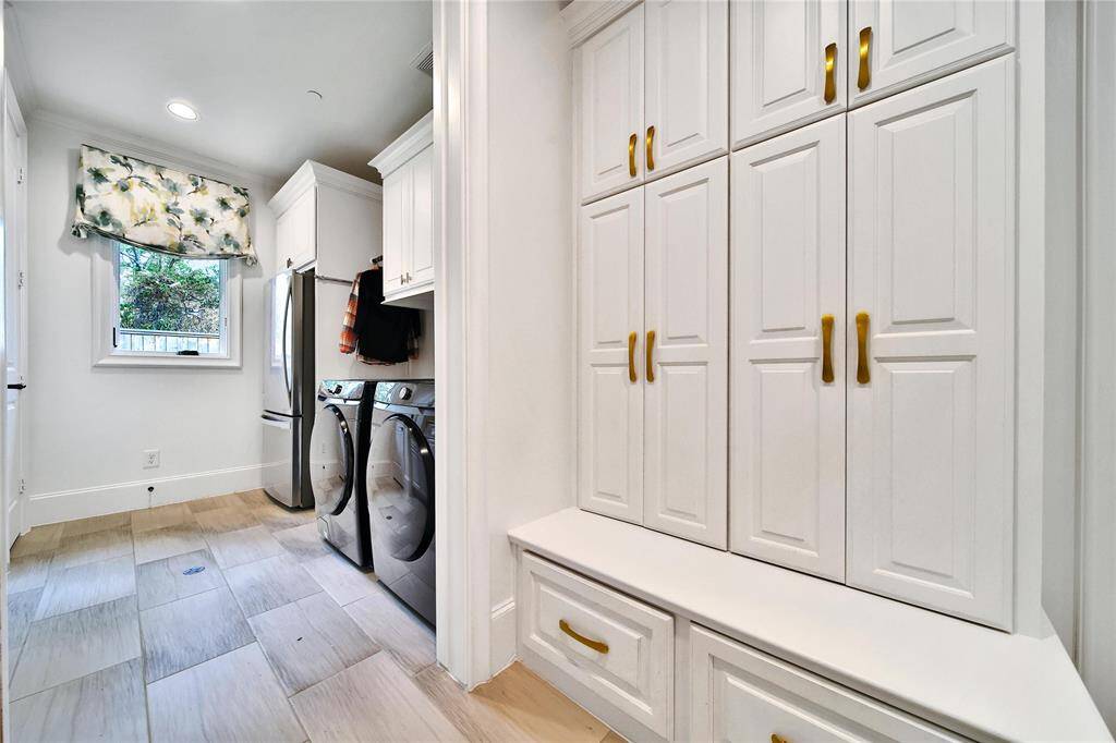 Expansive laundry room with sink and ample storage.