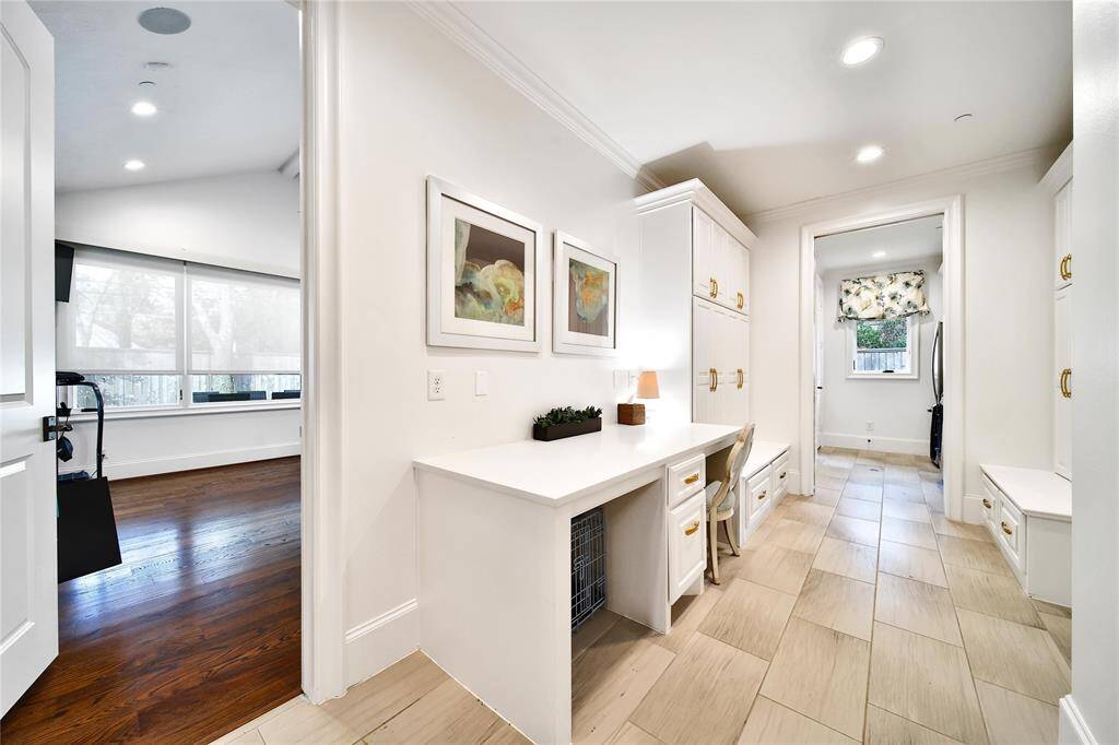 Spacious mudroom leading to laundry and flex room.