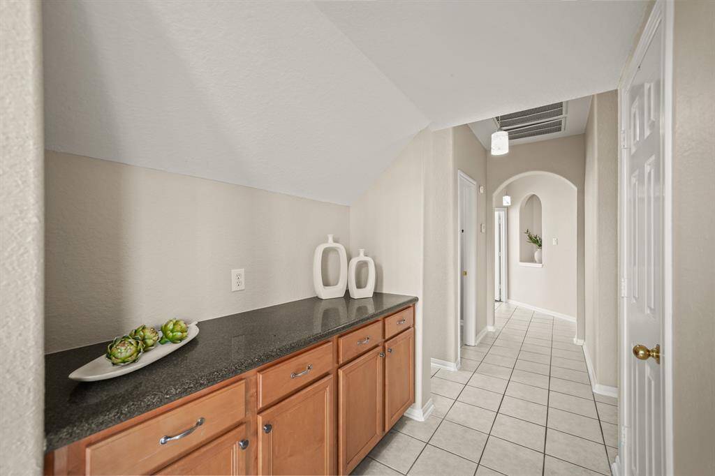 The Butler's Pantry is situated between the formal dining room and the kitchen. It provides additional storage for serving pieces, China, etc.