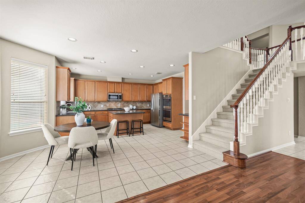 The kitchen and breakfast nook have recessed lighting and overlook the pool and backyard.