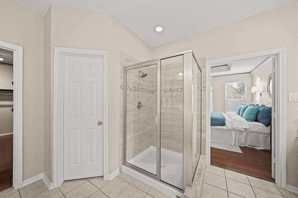 The shower glass and frame have been updated. The tiles walls have a pretty decorative accent.