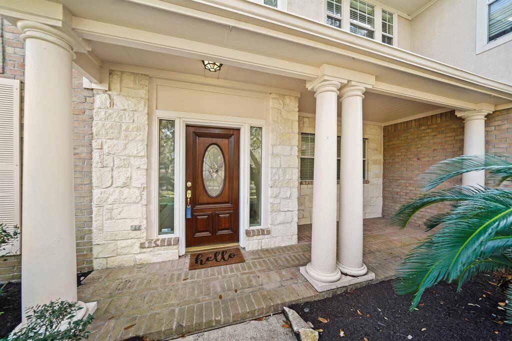 The inviting entrance has decorative columns and an upgraded brick front porch.