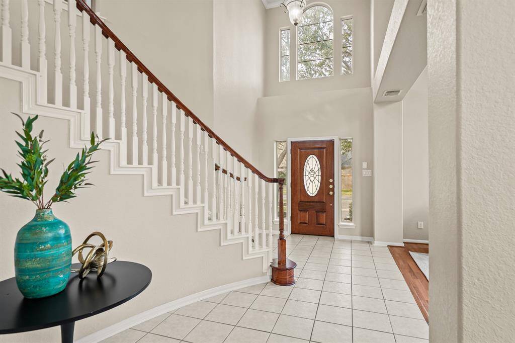 This home is light and bright. The front door has side light windows and an arched window with side lights above to let the outside in!