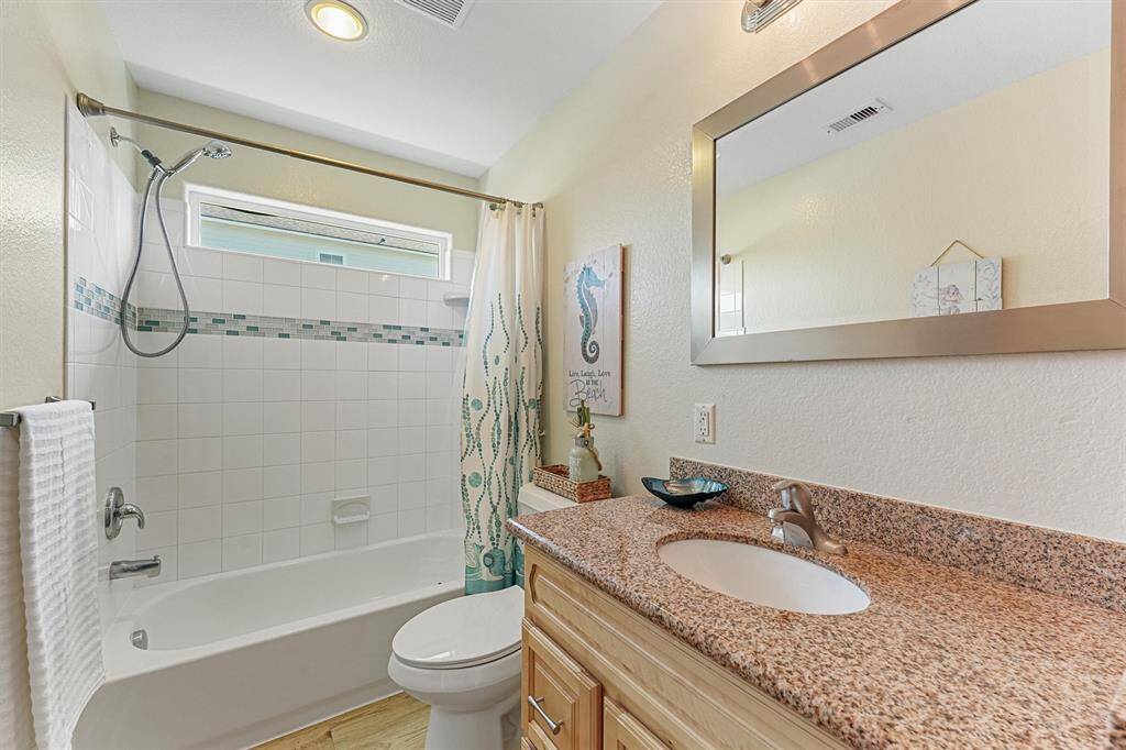 Full bathroom with custom tiles.