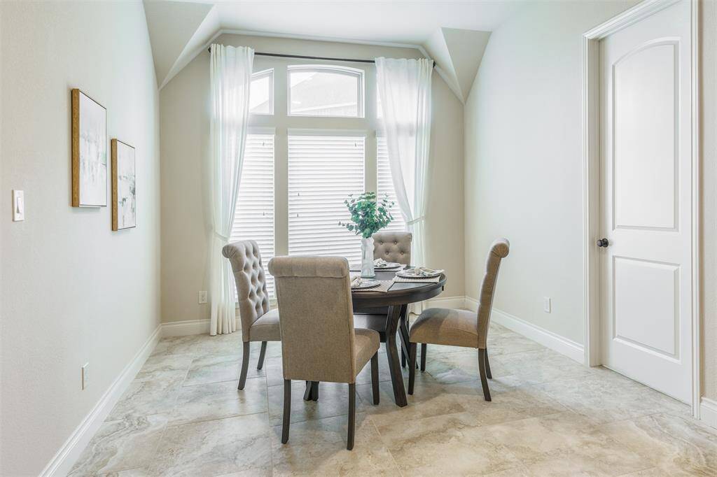 This cheerful breakfast room features windows to bring in lots of natural light! What a perfect place to start your day with a morning cup of coffee and breakfast!