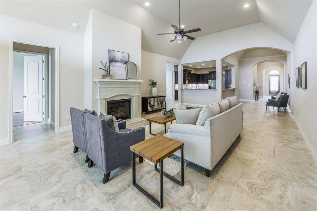 This bright and airy living space boasts an open floor plan where the family room, kitchen and front entry all flow together seamlessly. With natural light pouring in and gorgeous tile flooring throughout, it’s the perfect spot for gathering, entertaining, or just kicking back and relaxing.