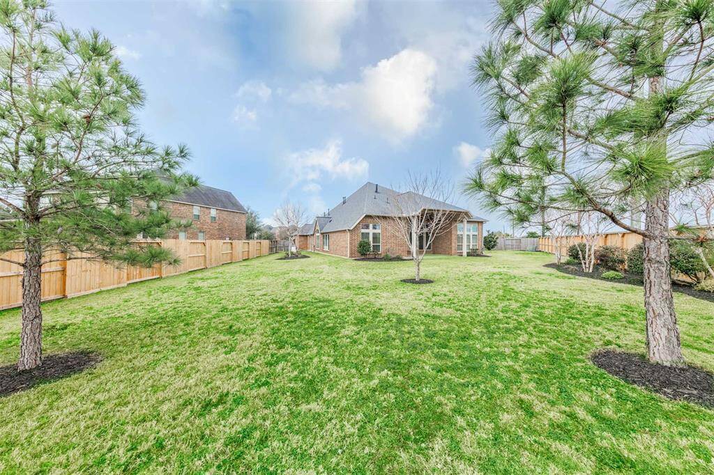 Step out back to a spacious covered patio with recessed lighting, overlooking an enormous backyard with a new fence (2024)  - perfect for family cookouts, outdoor entertaining, and making memories with friends. Plus, enjoy extra privacy of having no back neighbors!
