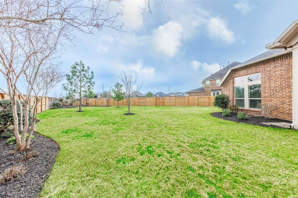 Endless possibilities await in this expansive backyard, set on a 16,000+ sq. ft. lot of lush green space! Whether you envision a custom pool and spa, a playset for the kids or your own outdoor retreat, there’s plenty of room to bring your dreams to life.