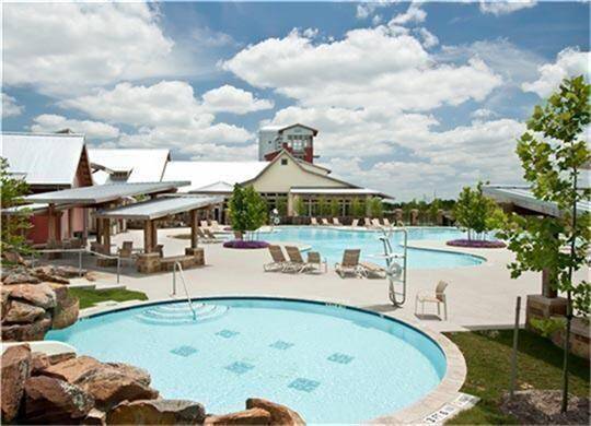 This is one of the 3 pools throughout the community. Cross Creek Ranch offers a swim team too!! Splash pad and views of the lake bring resort style living home. The Cross Creek Ranch lookout tower is in the distance.