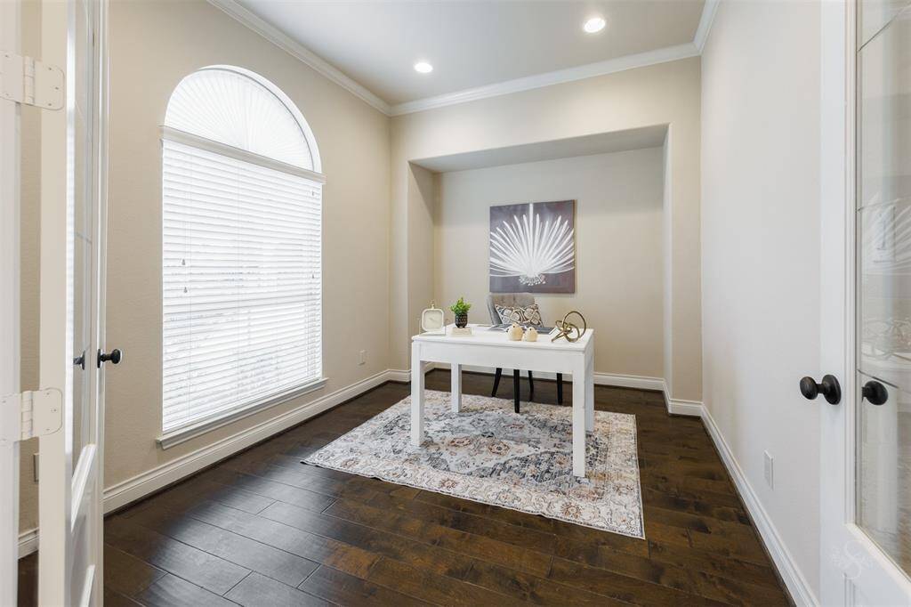 The formal study provides the perfect place for an in-home office featuring double glass front doors, high ceiling with crown molding, recessed lighting and room for a desk, bookcases and accessories in a quiet environment.