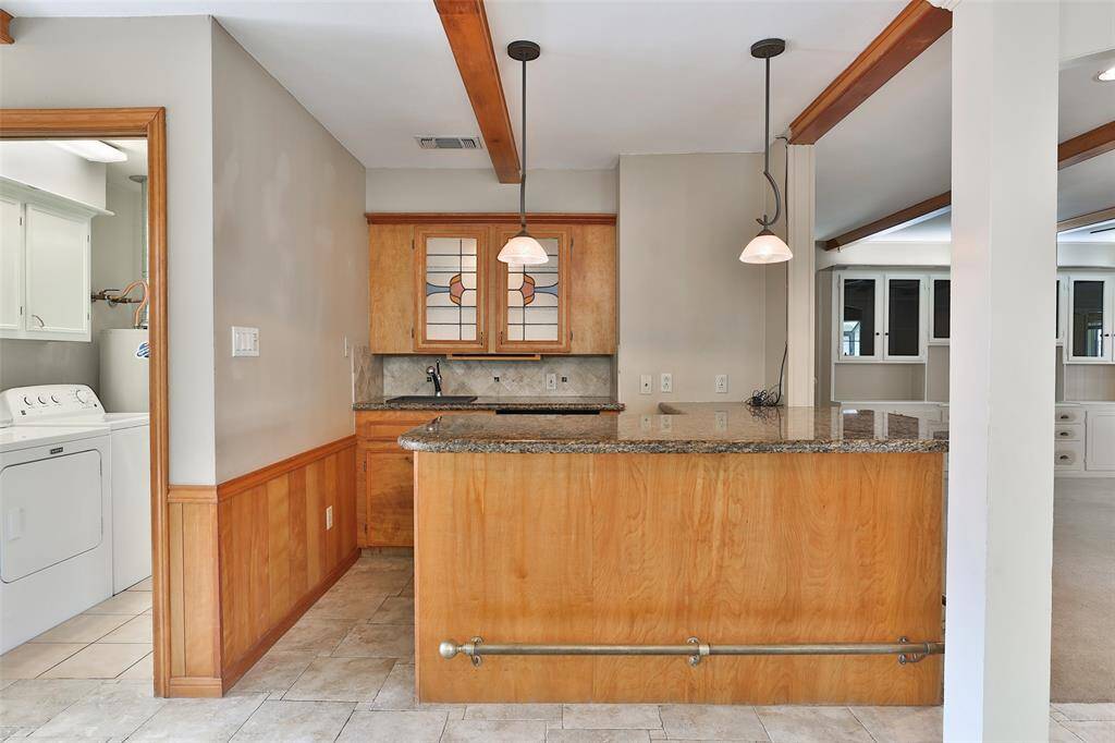 Who would not want to entertain with access to this wet bar!  You have lots of cabinets, granite countertops and separate under the counter refrigerator with ice maker.