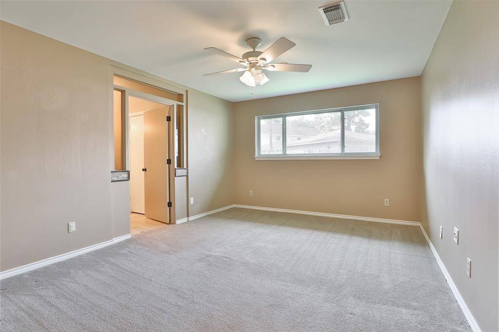 Primary bedroom which features double paned window and 2 walk-in closets!