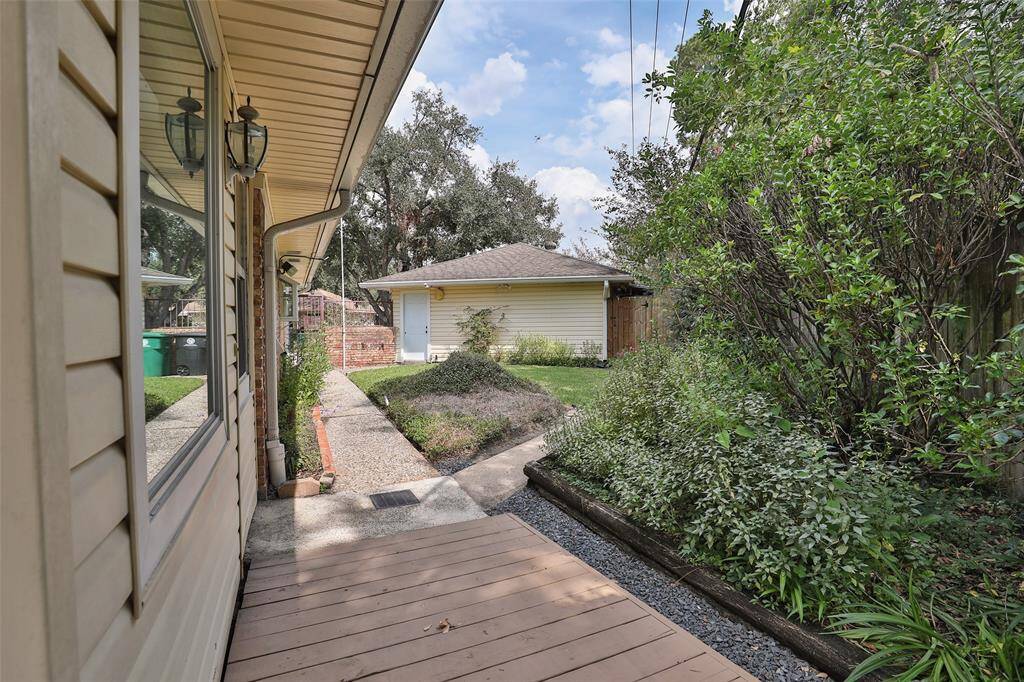 Side yard between the house and garage.