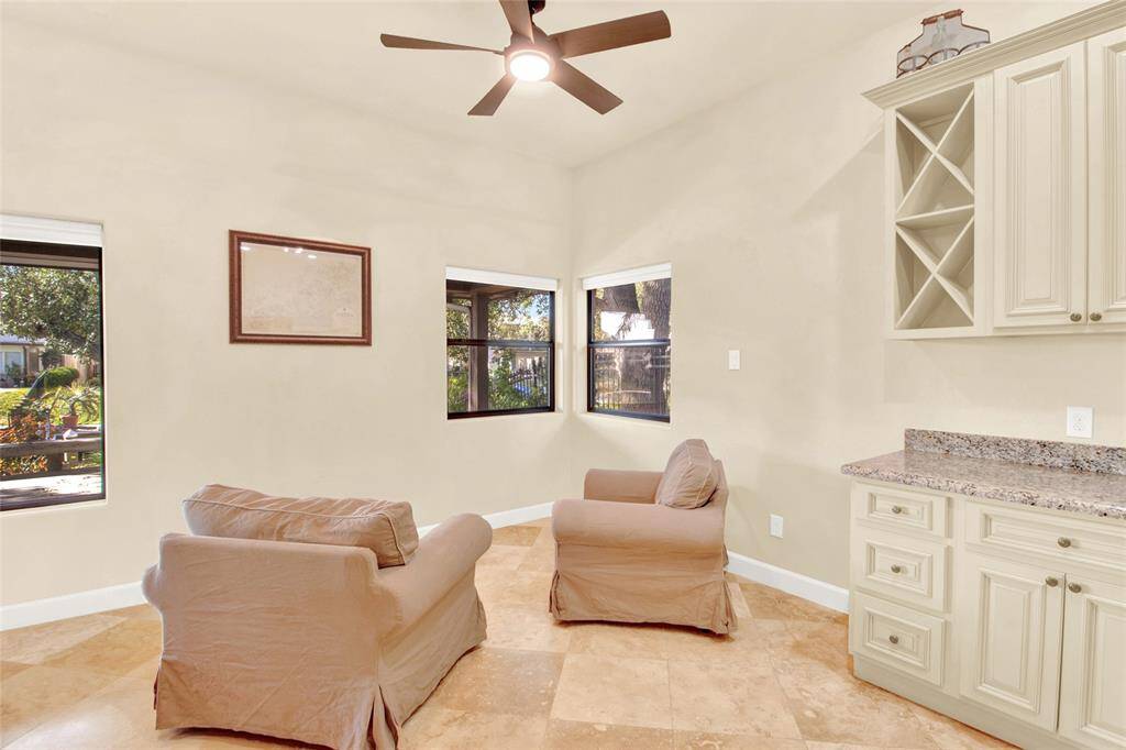 Beautiful Dining Or Conversation Area....Quite The View With Waterfront And Mature Landscaping Seen Through The Wall Of Windows!