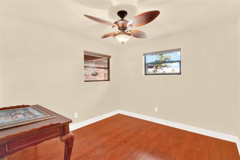 Secondary Bedroom With Multiple Windows And Wood Flooring!