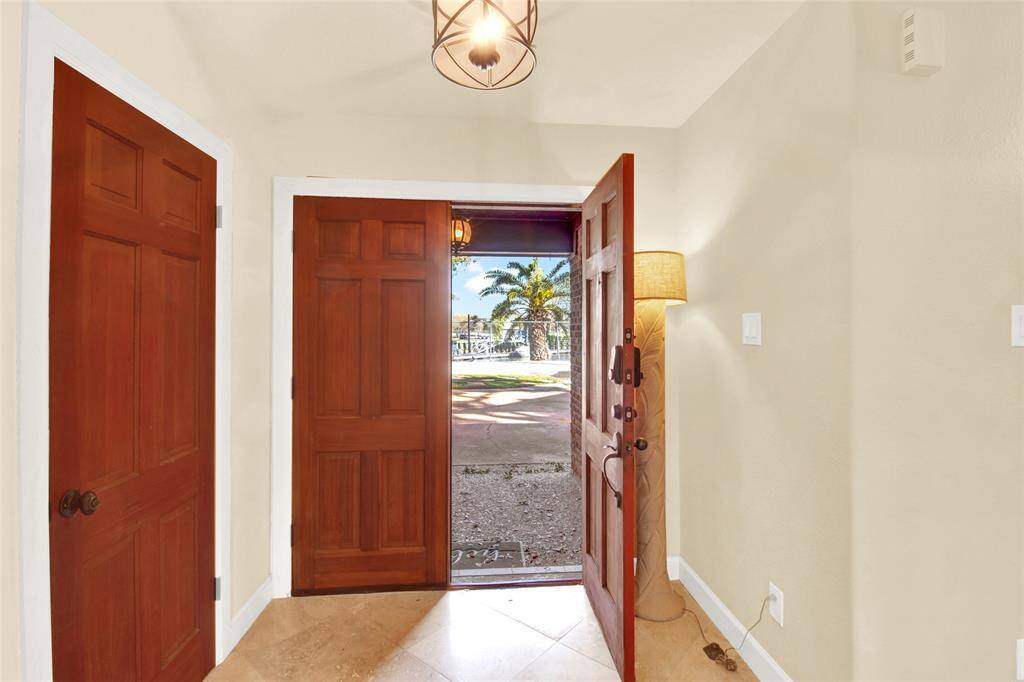 A Set Of Solid Wood Double Doors Invites You Into The Foyer...