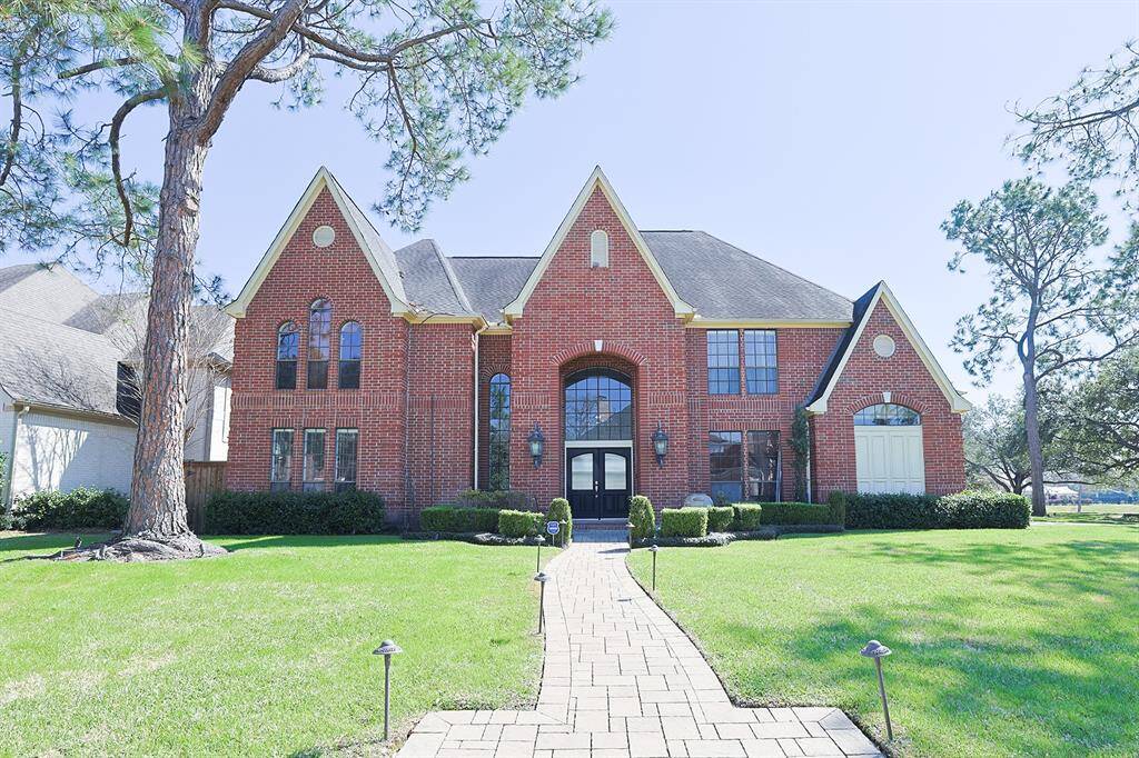 A grand brick facade with elegant architectural details welcomes you to this stunning home.