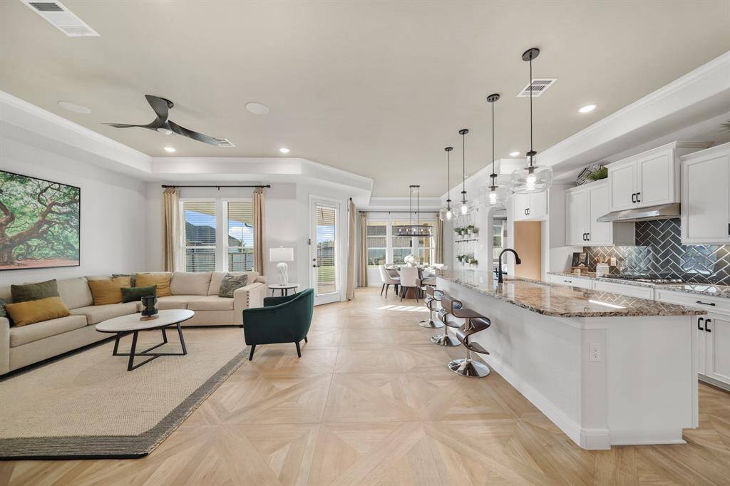 Flowing effortlessly from the kitchen, the spacious living room offers a cozy yet elegant setting for everyday living.
