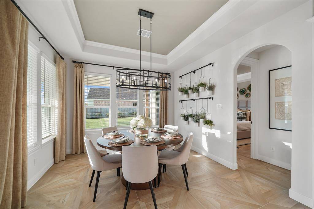 Enjoy morning coffee in this sunlit breakfast room, perfectly positioned between the kitchen and family room for effortless dining