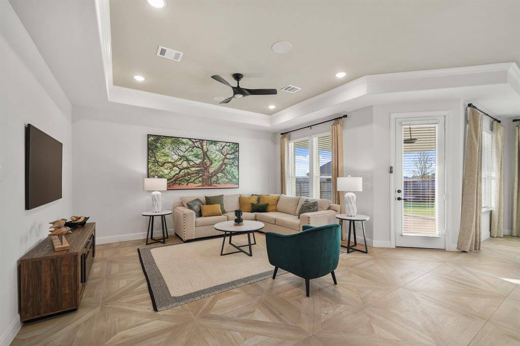 Whether entertaining or relaxing, this inviting living space offers an airy ambiance and easy access to the heart of the home.
