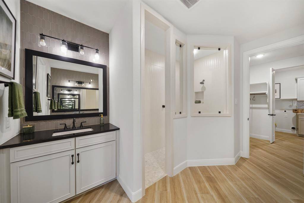 Step into spa-like luxury with this primary ensuite, showcasing dual vanities, premium finishes, and a custom oversized shower.