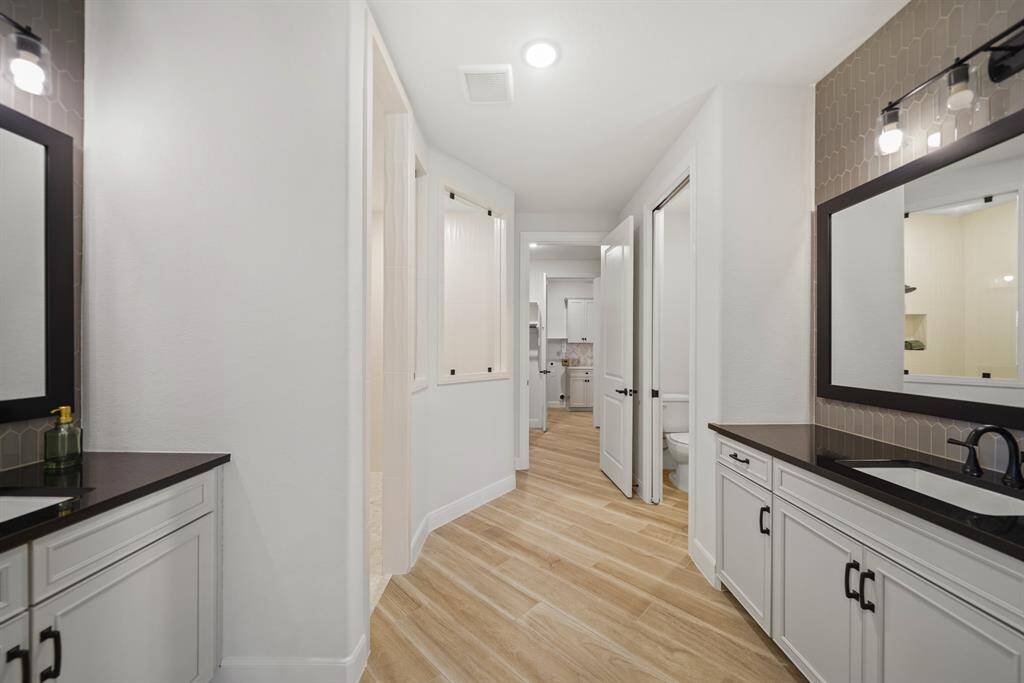 Step into spa-like luxury with this primary ensuite, showcasing dual vanities, premium finishes, and a custom oversized shower.