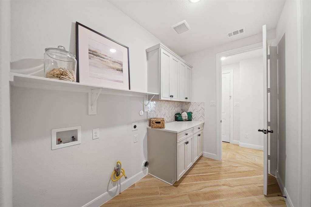 Ample space in this laundry room with extra storage.