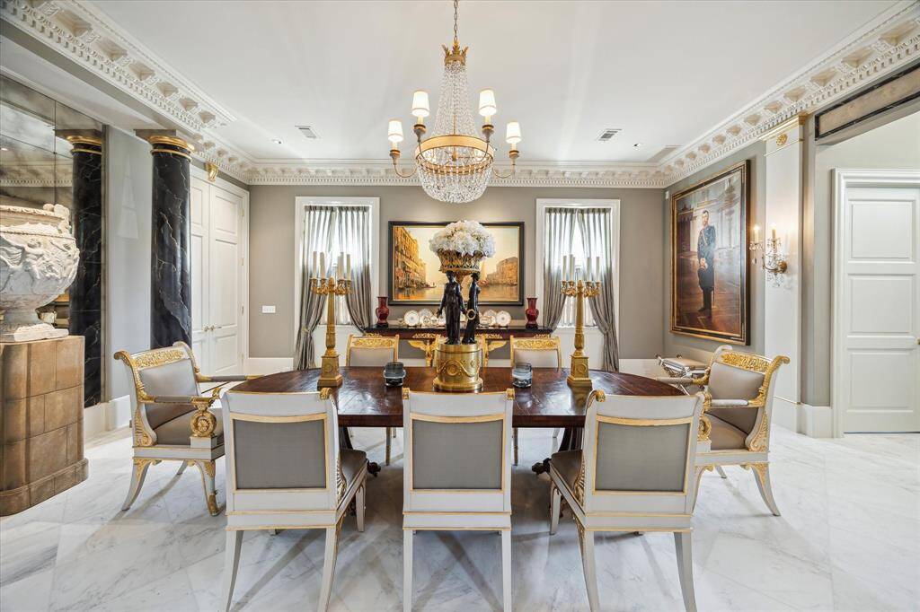 22x22 dining room with marble floor, molding with incredible details, sophisticated lighting and high ceiling.