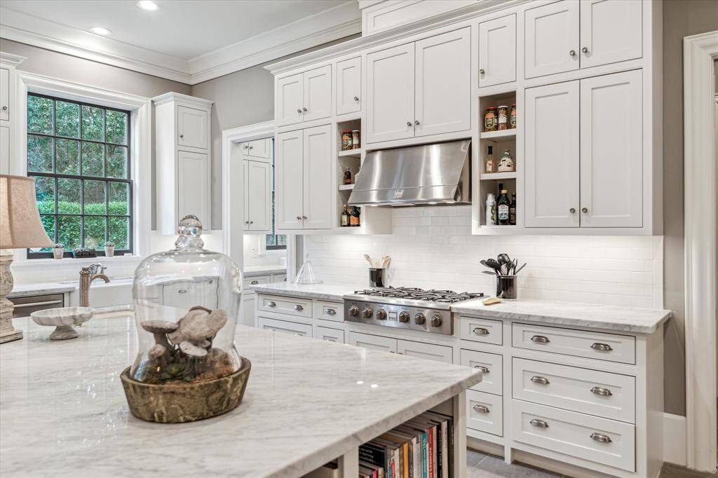 The kitchen is complete with a six burner cooktop, large vent hood and abundant storage.