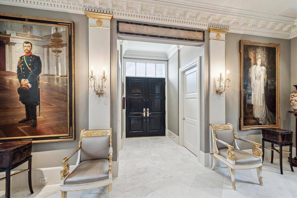 The entry to the home features double front door, marble floor, high ceiling, exquisite moldings and an inviting presence.