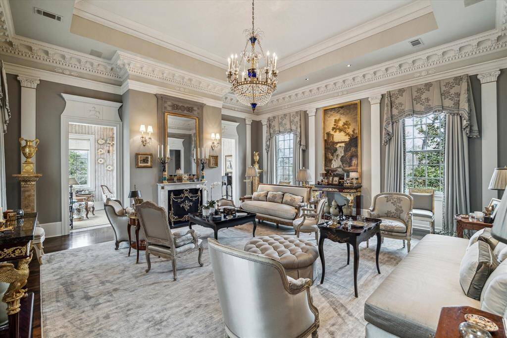 The formal living room with luxurious carpet, tree lined views, huge windows and 15ft ceiling.