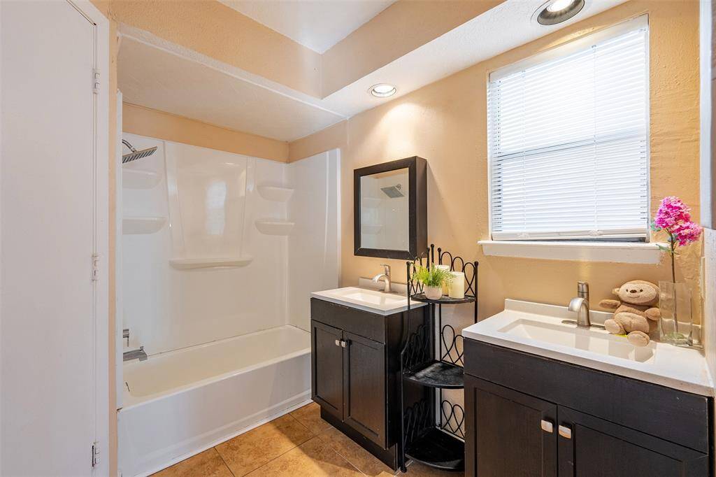 The primary bath features a his-and-her vanity and a spacious walk-in closet, providing both convenience and ample storage.