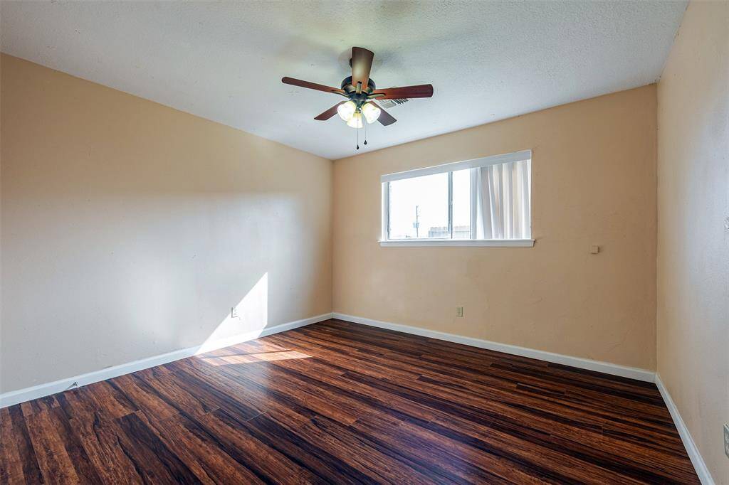 The spacious second bedroom features a ceiling fan with lighting and a walk-in closet for comfort and ample storage.