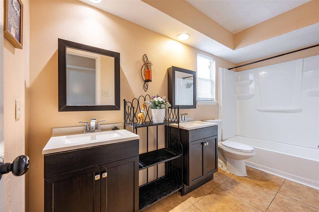 The spacious second bath features a double vanity and a dedicated linen space.
