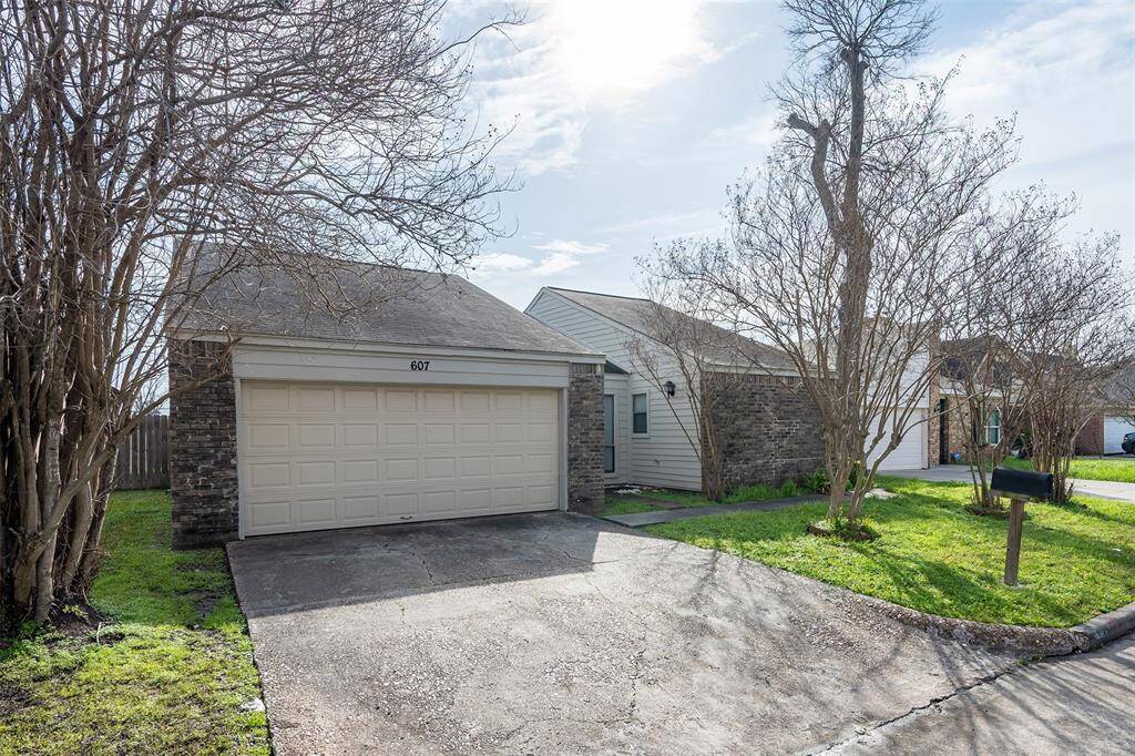 The garage features a double-wide driveway, providing ample parking space for multiple vehicles and easy access.
