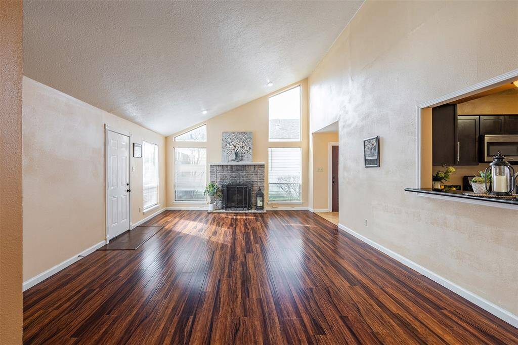 Another view of the living room.  Enjoy the beautiful wood-look floors and an abundance of natural light that enhances the home's warmth and charm.