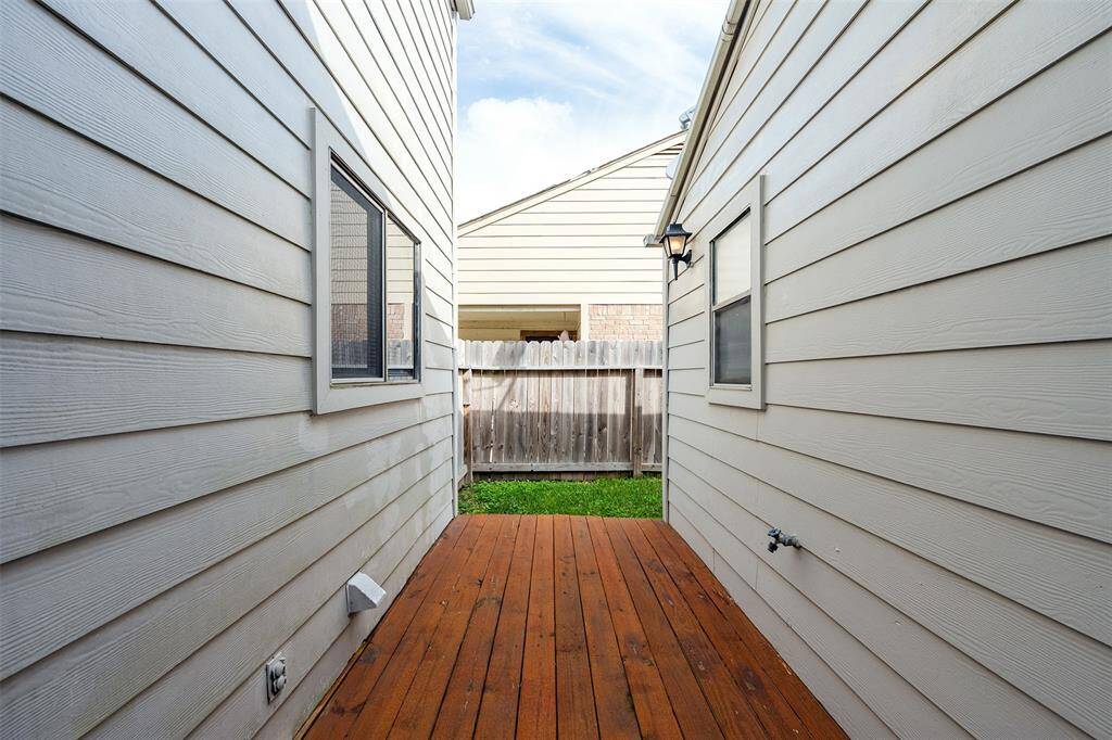 The wood deck patio is conveniently located just outside the French doors, perfect for relaxing or entertaining.