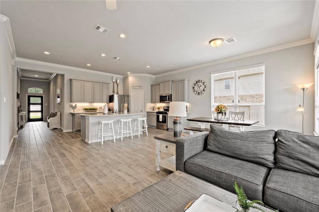 Views of the entry way and the kitchen from the living room