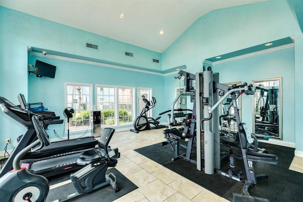Condo complex has a fitness center next to the clubhouse/office.
