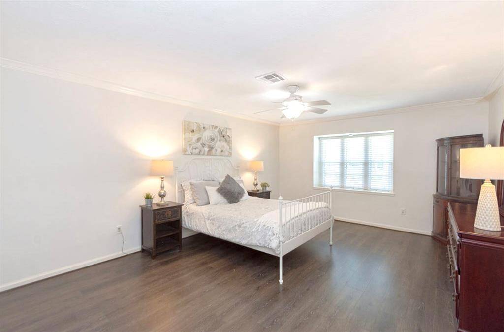 The Owner Suite is huge! It has updated paint, LVP flooring, a window seat space, and ceiling fan + light!