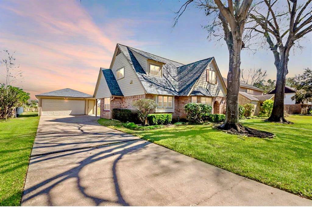 This view showcases the long driveway that leads to your attached/detached garage! There is an entrance off of the back close to the garage!Photo enhanced.