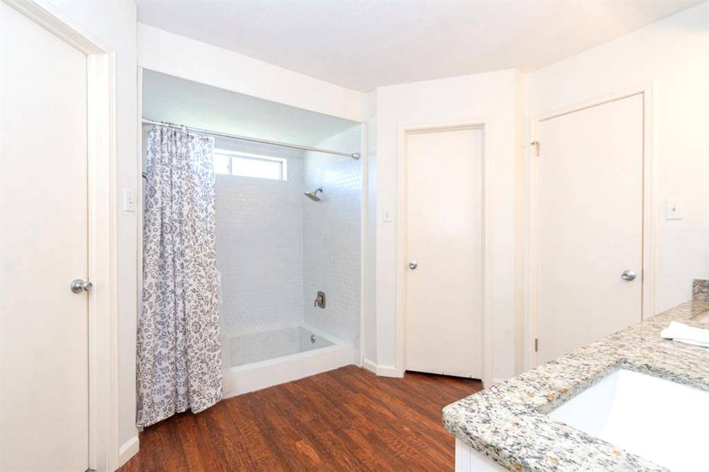 The Owner Bath has an updated shower surround, updated painted and wood laminate flooring!