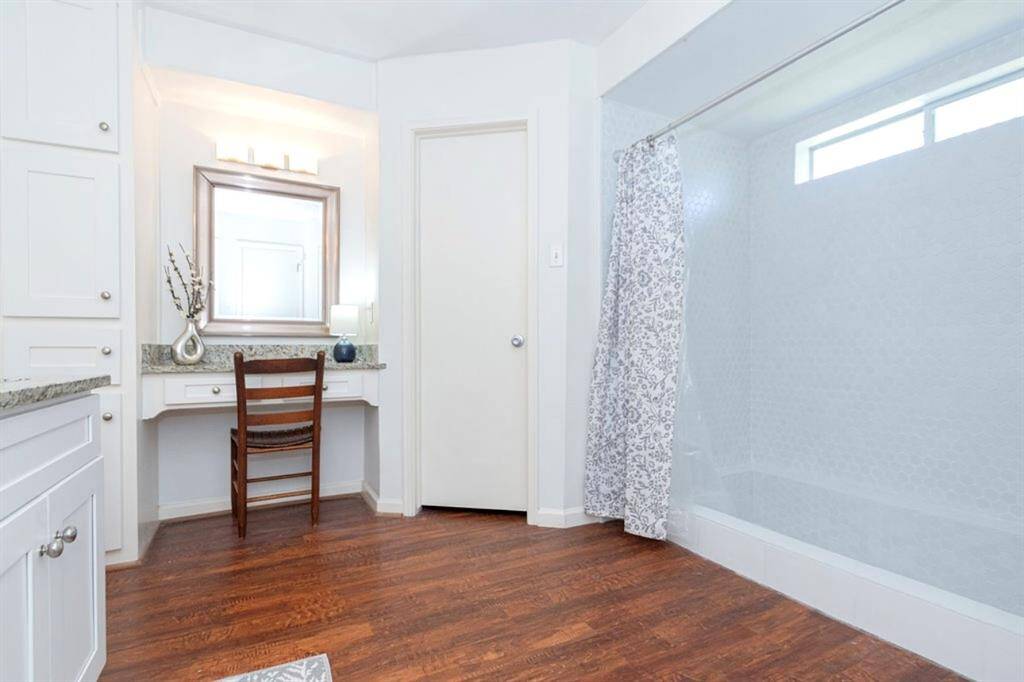 A built in Vanity with drawers and a linen closet is to the left for additional storage!