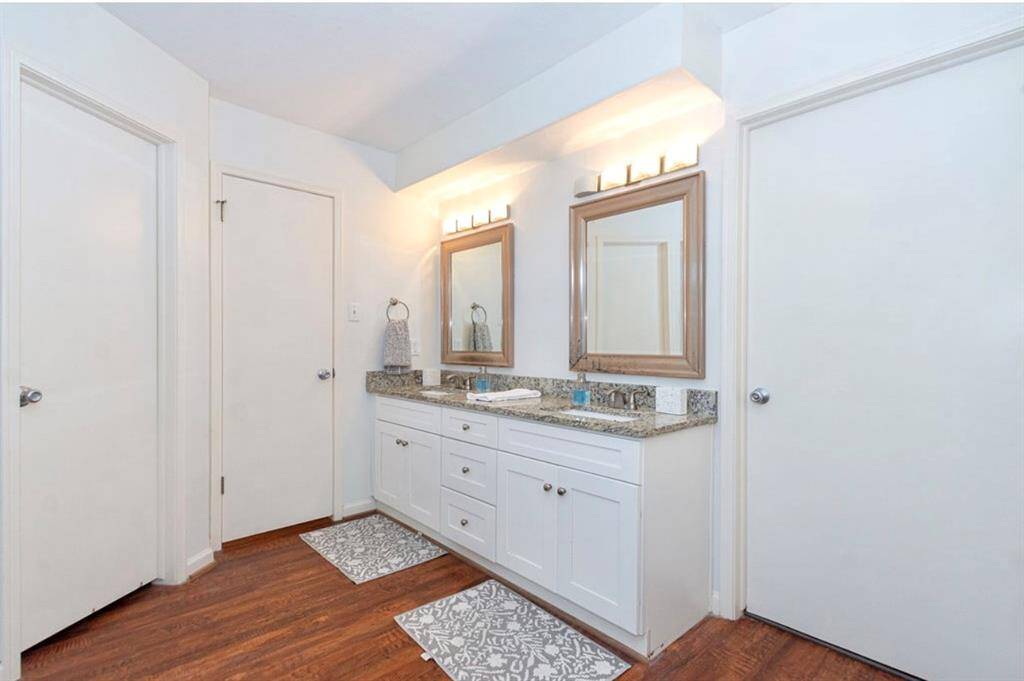 The Owner bath has updated lighting, mirrors, undermount sinks, granite counters and white woodwork cabinetry! So stunning!