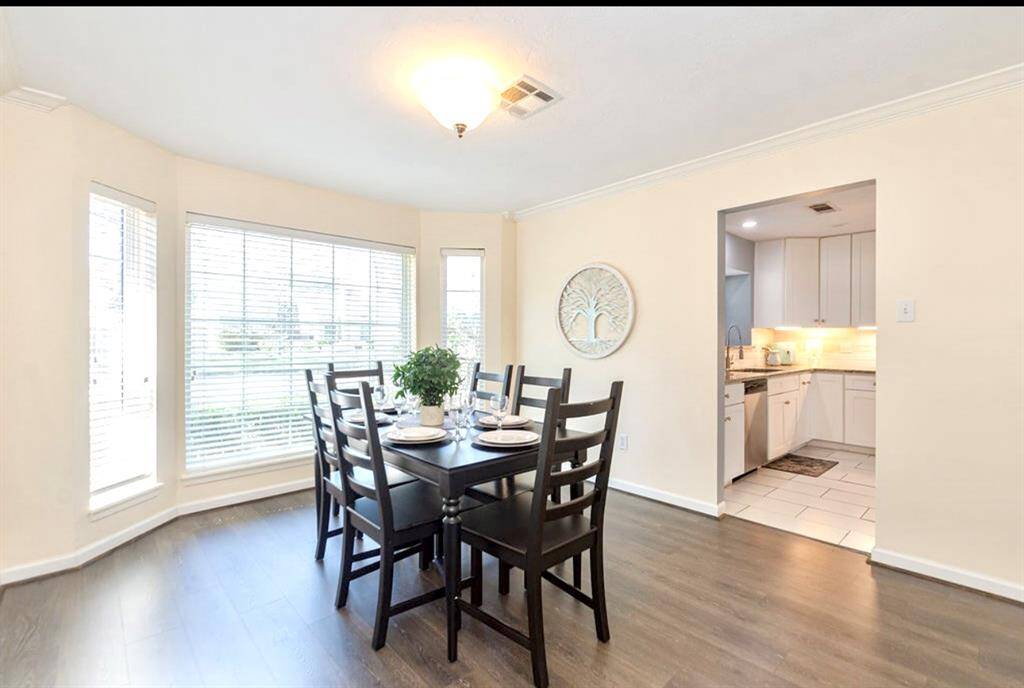 To left of your entry is your delightful Dining Room! It features a beautiful bay window that overlooks the front yard with Low E Double Pane Windows, updated lighting and LVP flooring (2023)!